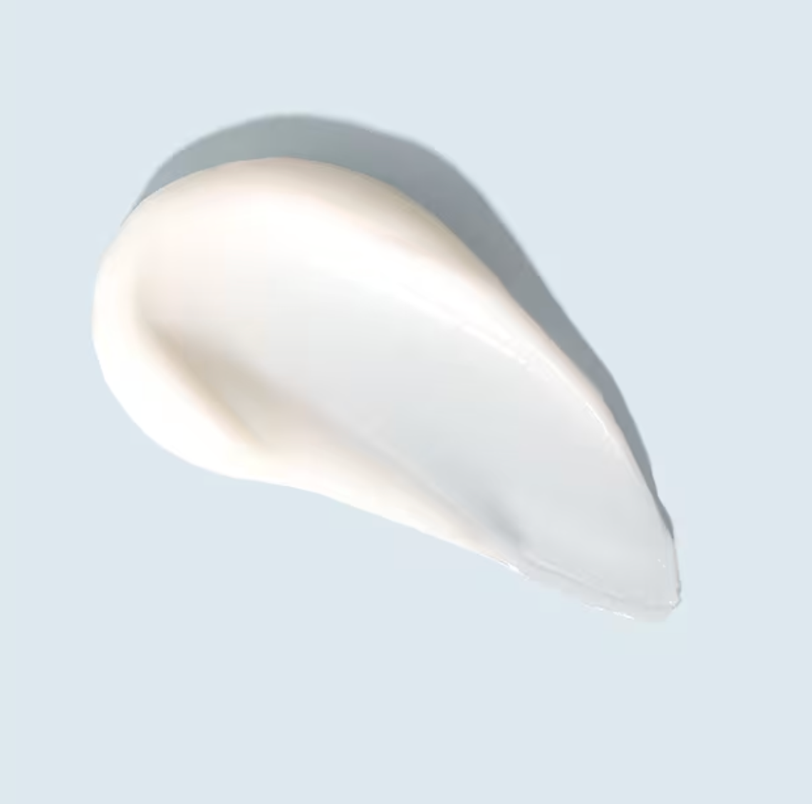 White cosmetic cream on a light gray background