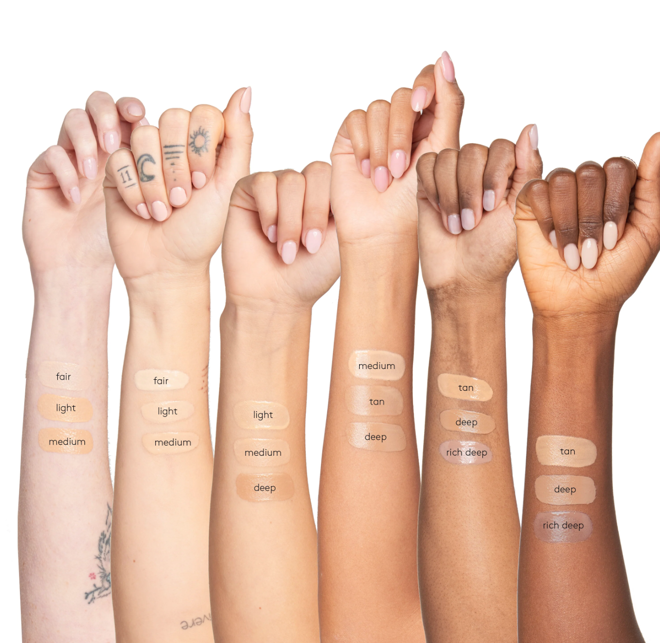 Hands with various skin tones displaying different makeup product swatches.