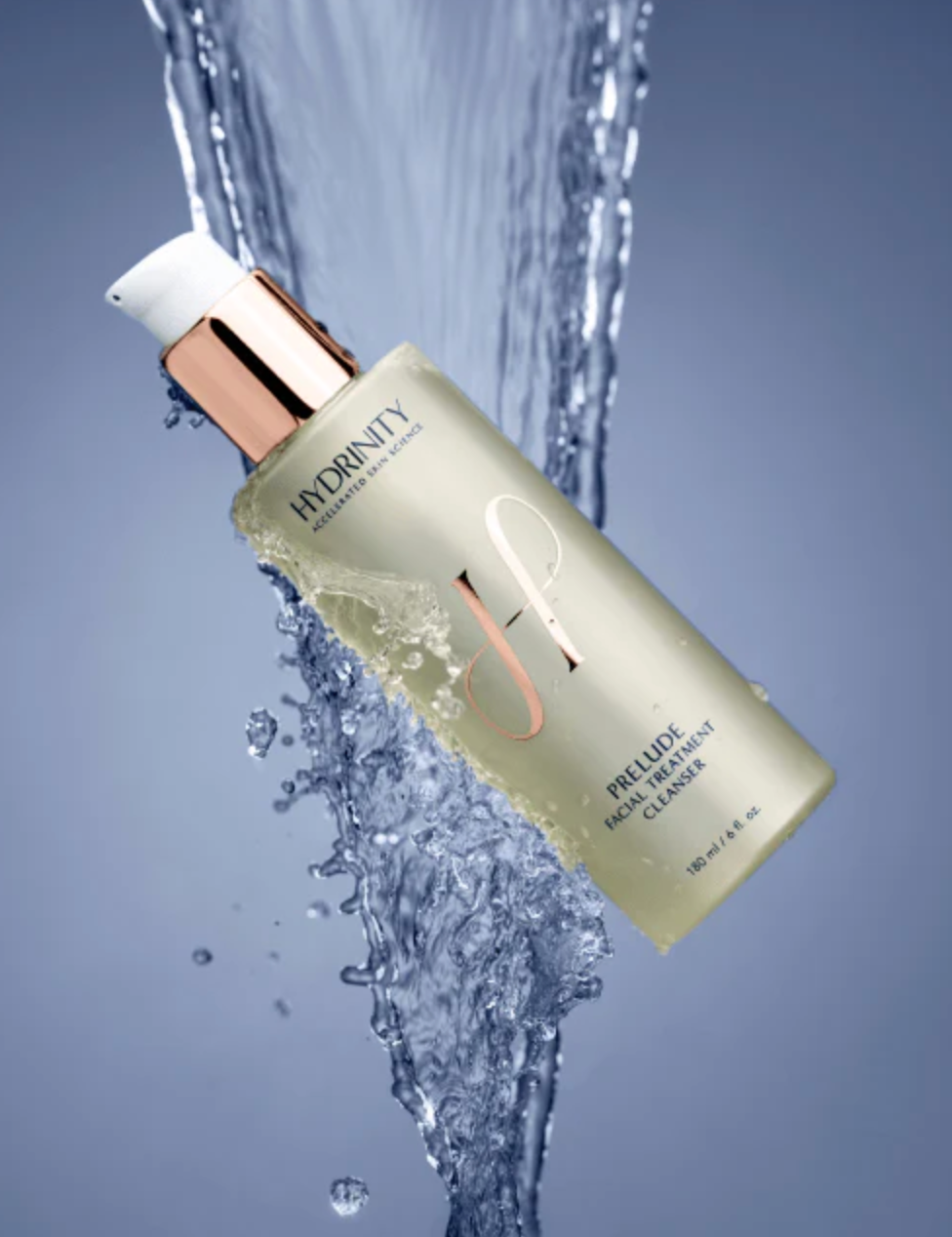 Skincare bottle with water splash on a gray background