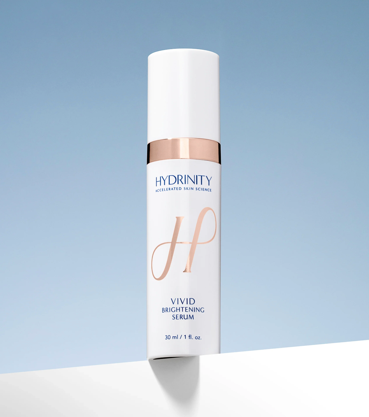 Hydrinity Vivid Brightening Serum bottle on a light blue background
