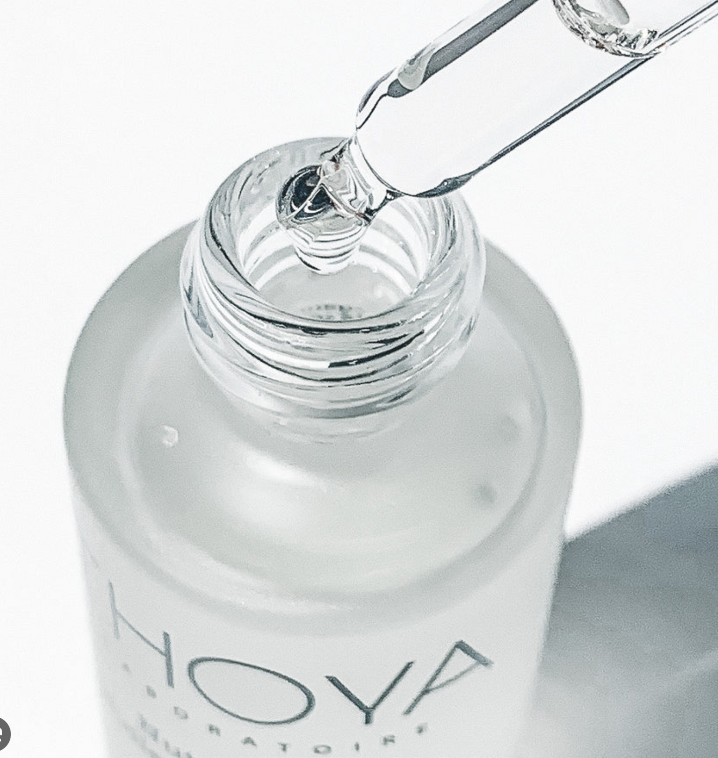 Bottle of Hoya liquid with a dropper on a white background