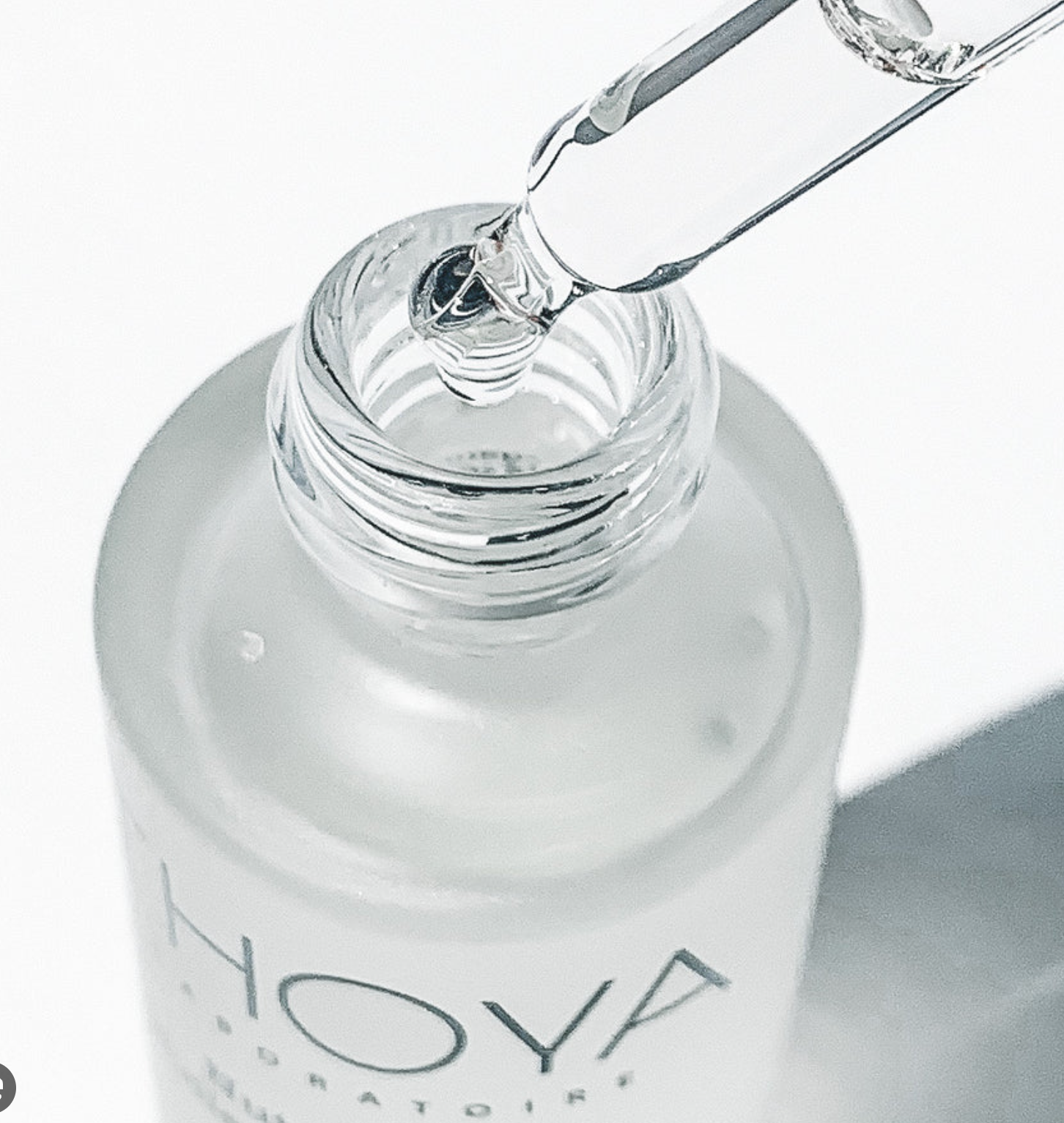 Bottle of Hoya liquid with a dropper on a white background