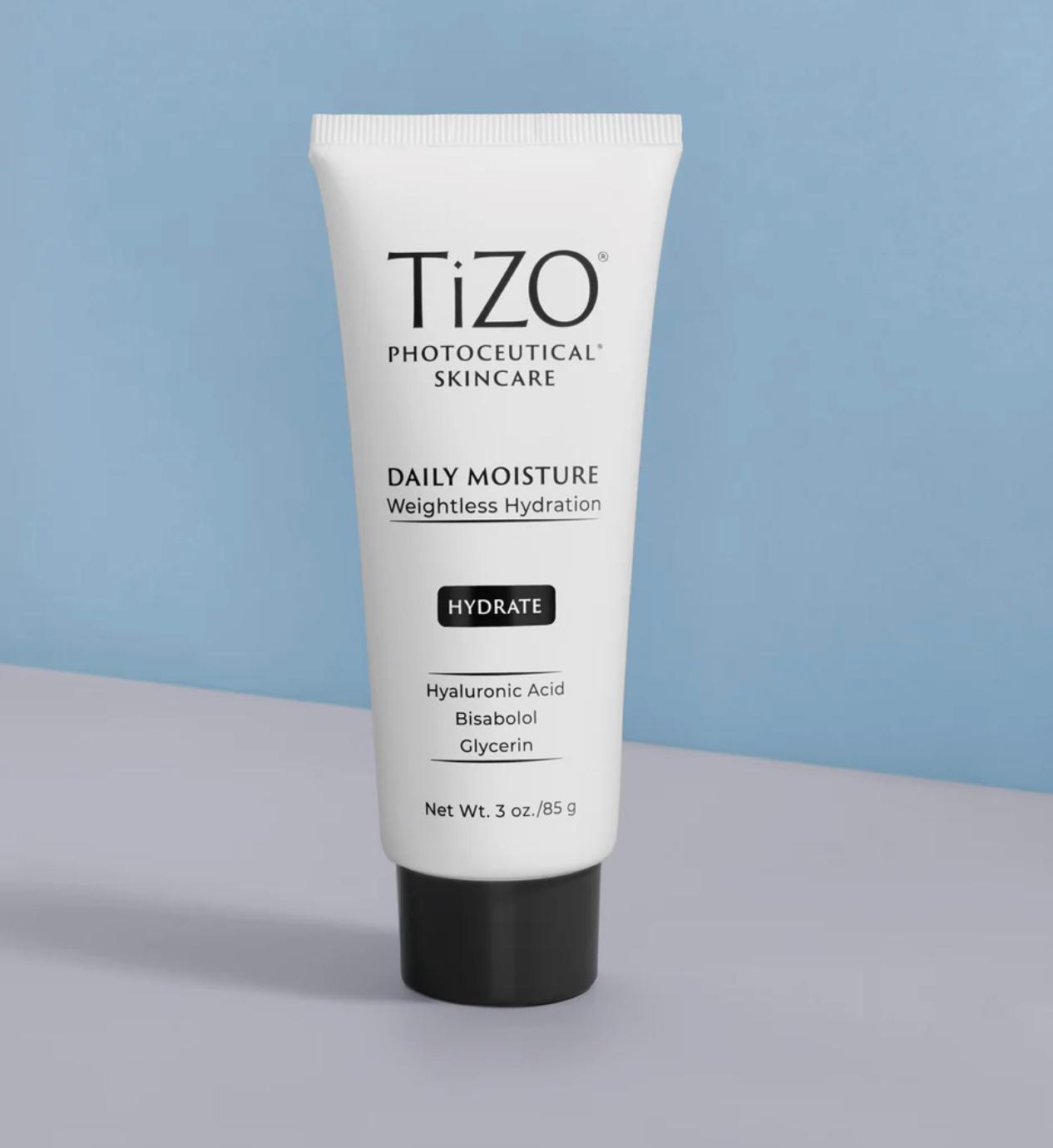 Tizo Daily Moisture skincare tube on a gray surface with a light blue background