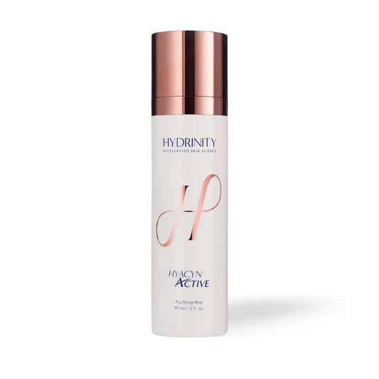 Skincare bottle with rose gold cap and branding on a white background